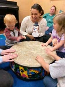 Pre-COVID: AMT's music therapist Anissa is pictured with young children and their parents in an early childhood music class.