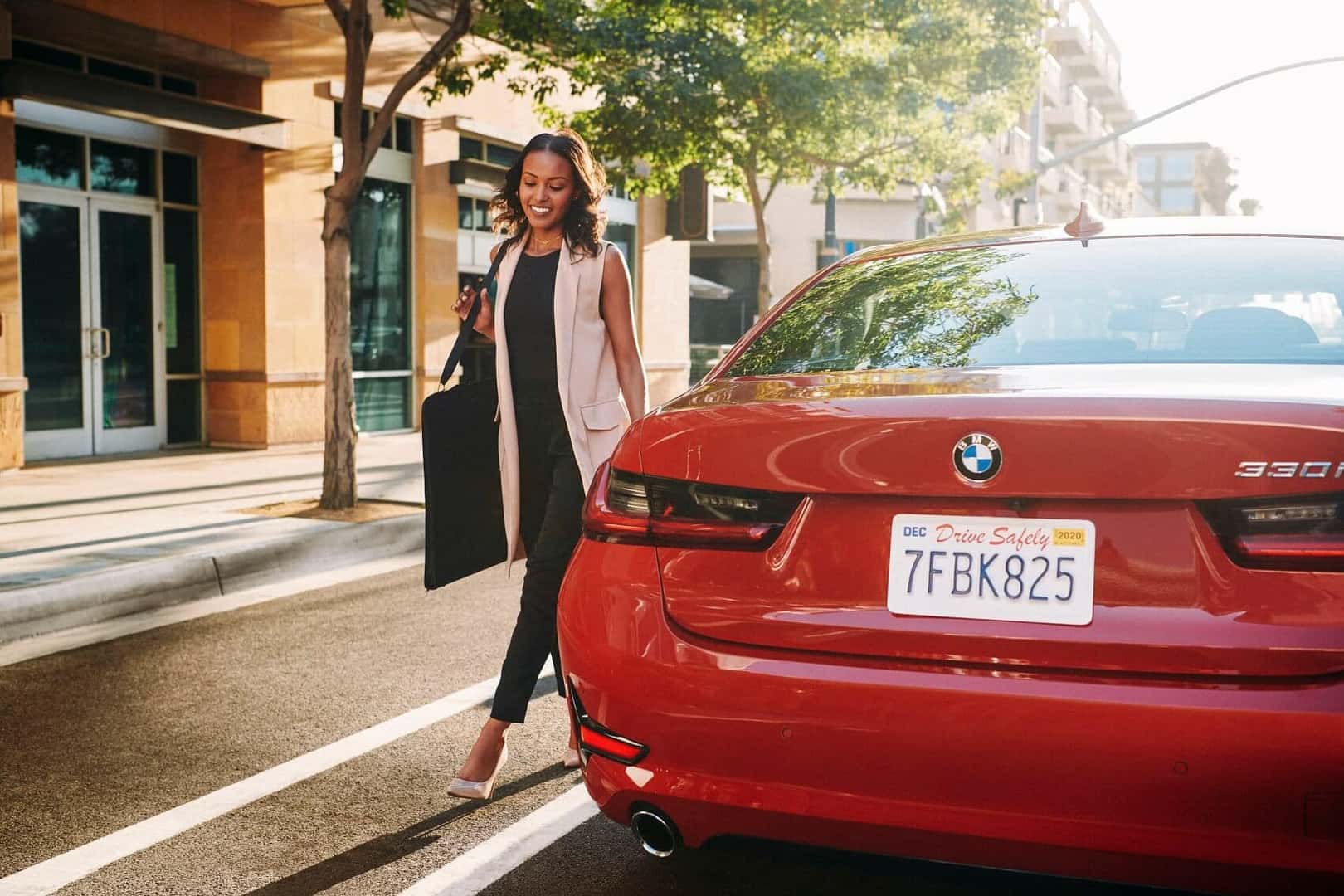 Woman Standing Next to Red BMW