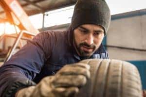 Service Tech Checking Tires