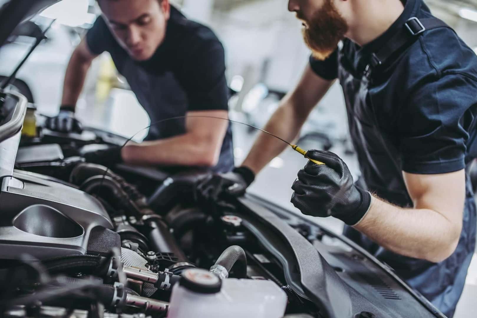 Service technicians working on a used car