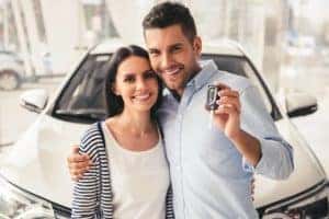 couple getting keys of used car 