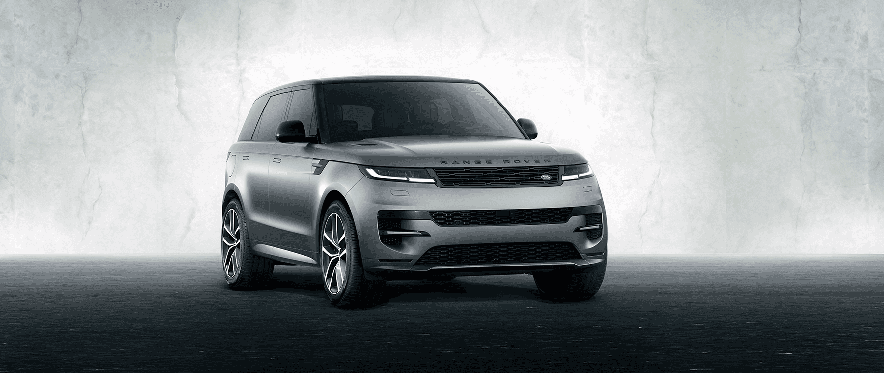 Image features Silver Range Rover Sport.