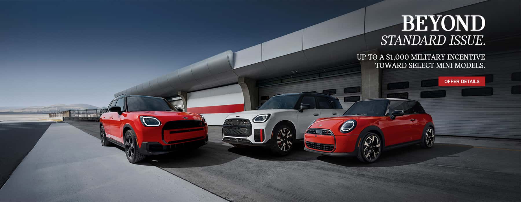3 MINI's parked in front of a plane hanger.