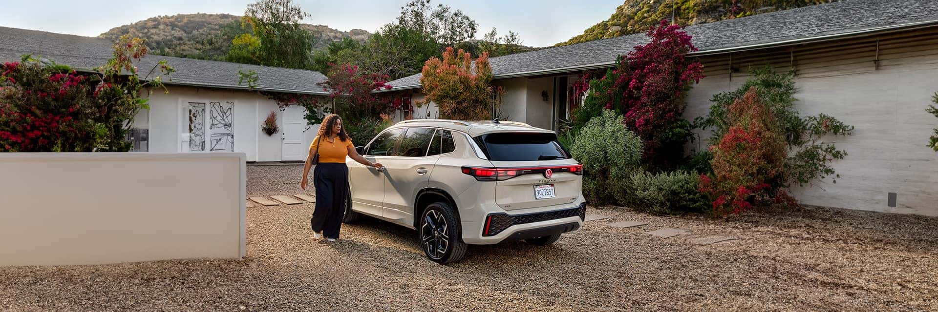 Woman getting in tiguan in driveway